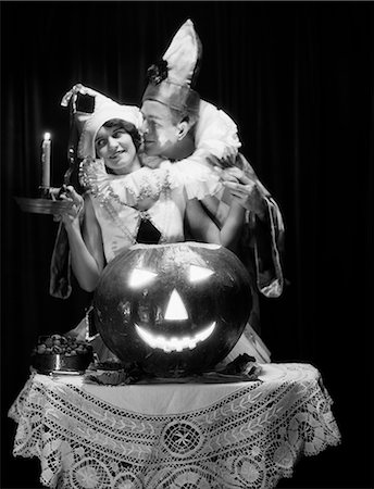 simsearch:846-06112056,k - 1920s ROMANTIC COUPLE WEARING COSTUMES WITH LARGE CARVED PUMPKIN JACK-O-LANTERN ON TABLE Stock Photo - Rights-Managed, Code: 846-08226104