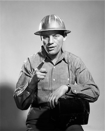 simsearch:846-08226158,k - 1960S MAN HARD HAT ARM OVER TIN LUNCHBOX SPEAKING POINTING FINGER Stock Photo - Rights-Managed, Code: 846-08226158