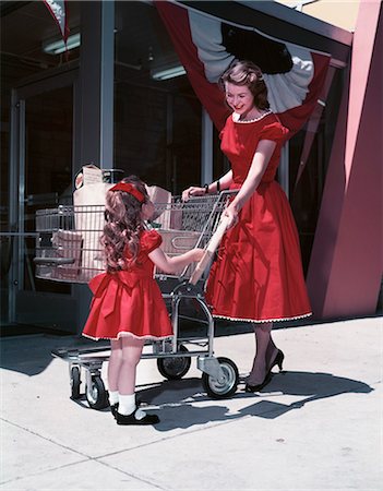 simsearch:846-05646041,k - 1950s MOTHER AND DAUGHTER WEARING MATCHING RED DRESSES OUTSIDE SUPERMARKET Stock Photo - Rights-Managed, Code: 846-08512729