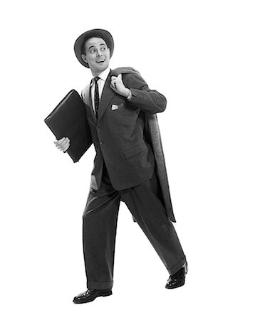 face funny - 1950s SALESMAN BUSINESSMAN BRIEFCASE HAT WALKING COAT OVER SHOULDER SMILING EXPRESSION LOOKING BACK OVER SHOULDER AT COMPETITION Stock Photo - Rights-Managed, Code: 846-08512749