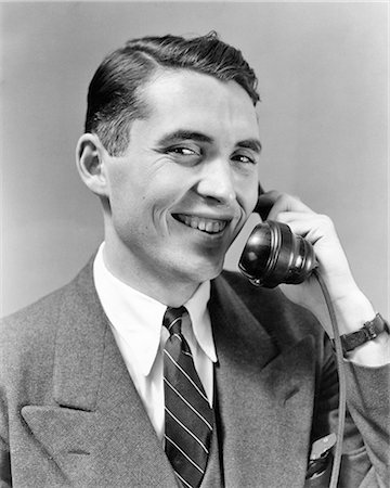 studio portrait talking - 1940s 1950s MAN IN SUIT TALKING ON TELEPHONE SMILING LOOKING AT CAMERA Photographie de stock - Rights-Managed, Code: 846-08721128