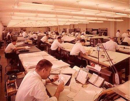 designer copyspace - 1960s ROOM FULL OF MANY MEN DESIGNERS WHITE COLLAR ARCHITECTS ENGINEERS SEATED AT DRAFTING TABLES WORKING Stock Photo - Rights-Managed, Code: 846-09012966