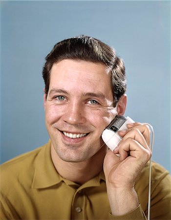 rasierapparat - 1960s SMILING MAN SHAVING WITH ELECTRIC RAZOR LOOKING AT CAMERA Stockbilder - Lizenzpflichtiges, Bildnummer: 846-09012985