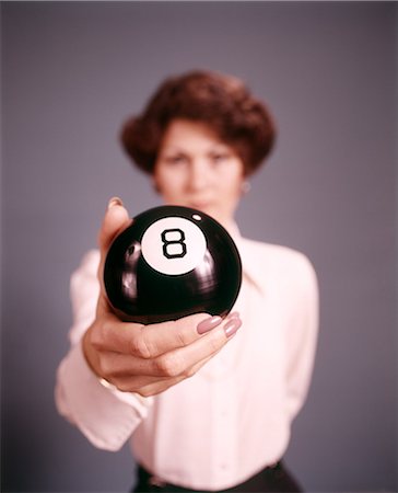 1970s WOMAN STANDING BEHIND HOLDING AN EIGHT BALL LOOKING AT CAMERA Foto de stock - Con derechos protegidos, Código: 846-09012997
