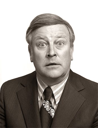 simsearch:846-09181636,k - 1970s PORTRAIT WIDE EYE BUSINESS MAN FUNNY FACE SHOWING FACIAL EXPRESSION SHOCK SURPRISE STARE FEAR AMAZEMENT WONDER Stock Photo - Rights-Managed, Code: 846-09013088