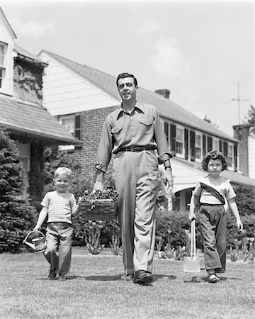 simsearch:846-09013066,k - 1950s FATHER WITH TWO CHILDREN DAUGHTER AND SON WALKING IN FRONT YARD CARRYING GARDENING TOOLS LOOKING AT CAMERA Stock Photo - Rights-Managed, Code: 846-09085298