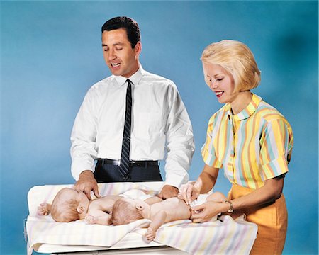 1960s MOTHER AND FATHER DIAPERING TWO TWIN BABIES CLOTH DIAPERS ON CHANGING TABLE Stockbilder - Lizenzpflichtiges, Bildnummer: 846-09085310