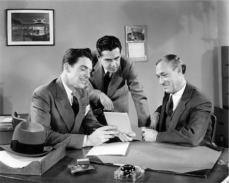 retro vintage occupations adults - 1940s THREE MEN AT OFFICE DESK LOOKING AT PAPERS TABLET MEETING Stock Photo - Rights-Managed, Code: 846-09085371