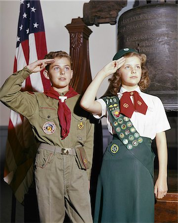 1960s BOY GIRL SCOUT IN UNIFORM SALUTING STANDING BY LIBERTY BELL IN INDEPENDENCE HALL PHILADELPHIA PA USA Stock Photo - Rights-Managed, Code: 846-09161483