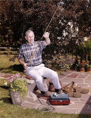 senior gardeners rubber boots - 1960s OLDER MAN SITTING IN BACKYARD WITH FISHING ROD AND GEAR TACKLE BOX BOOTS CREEL NET RETIRED HOBBY Stock Photo - Rights-Managed, Code: 846-09161534