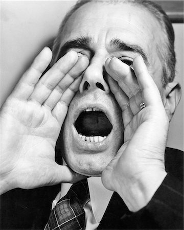 simsearch:846-08030377,k - 1950s MAN SHOUTING WITH HANDS CUPPED AROUND HIS MOUTH OPEN WIDE Stock Photo - Rights-Managed, Code: 846-09161576