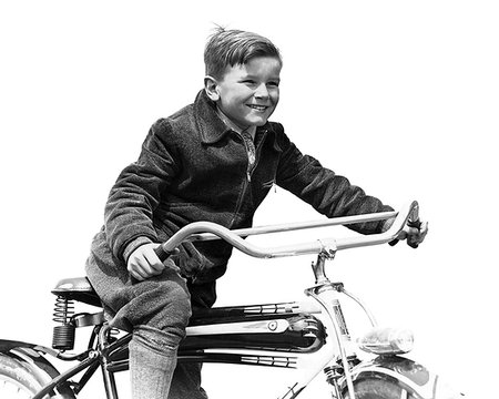 1930s SMILING BOY IN AUTUMN CORDUROY JACKET KNEE SOCKS AND PANTS  PEDALING HEAVY AMERICAN SPACE SHIP DESIGN STYLE BICYCLE Photographie de stock - Rights-Managed, Code: 846-09181581