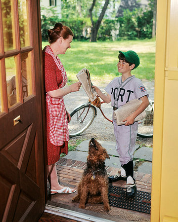 door delivery - 1970s NEWS CARRIER BOY HANDING NEWSPAPER TO WOMAN AT DOORWAY OF HOUSE AIREDALE DOG WATCHING Stock Photo - Rights-Managed, Code: 846-09181809