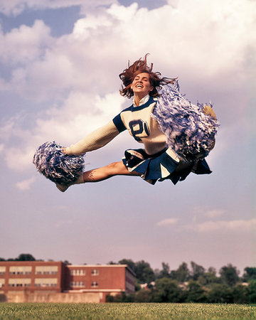 1960s 1960s GIRL CHEERLEADER IN MID AIR SPLIT JUMP SMILING BLUE & WHITE UNIFORM SKIRT POMPOMS JUMPING LEVITATE Photographie de stock - Rights-Managed, Code: 846-09181894