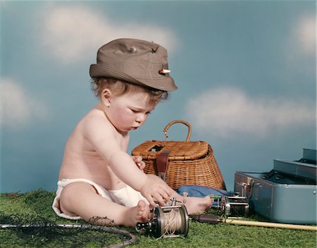 retro baby hat - 1960s BABY READY TO GO FISHING WEARING HAT SURROUNDED BY TACKLE BOX FISHING ROD NET BASKET Stock Photo - Rights-Managed, Code: 846-02794001