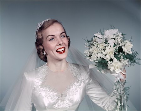 1950s BLOND BRIDE SMILING HOLDING ABOUT TO THROW WHITE BRIDAL BOUQUET FLOWERS GOWN LACE VEIL FASHION Stock Photo - Rights-Managed, Code: 846-02794049