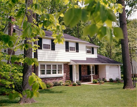 suburbia - 1970s SUBURBAN SPLIT LEVEL HOUSE WITH BLACK SHUTTERS BRICK SIDING AND LANDSCAPED LAWN Stock Photo - Rights-Managed, Code: 846-02794052