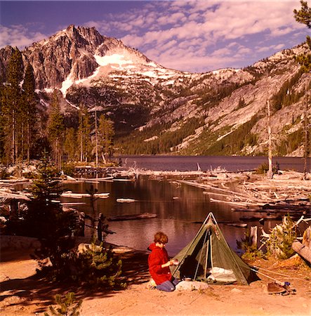 1970s TEEN BOY KNEELING CAMPSITE GREEN TENT TENTS WASHING TIN CUP SNOW LAKES MCCLELLAN PEAK WASHINGTON STATE Stock Photo - Rights-Managed, Code: 846-02794128