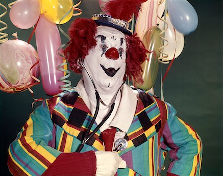 1960s FAT OVERWEIGHT CLOWN LISTENING TO HIS HEART WITH A MEDICAL STETHOSCOPE HEALTH SURPRISE WORRY CONCERN BALLOONS Stock Photo - Rights-Managed, Code: 846-02794140