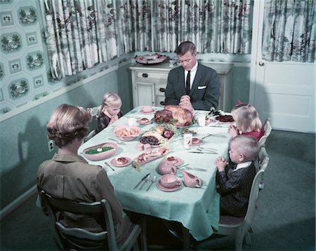 photo of family at dinner table - 1950s FAMILY SAYING GRACE BEFORE THANKSGIVING TURKEY DINNER MOTHER FATHER 3 CHILDREN Stock Photo - Rights-Managed, Code: 846-02794196