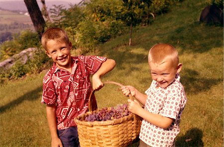 person carrying a fruit basket - 1960s TWO LAUGHING BOYS CARRYING BASKET OF HARVESTED GRAPES Stock Photo - Rights-Managed, Code: 846-02794213