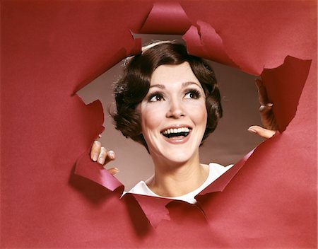 simsearch:846-02793087,k - 1960s PORTRAIT OF HAPPY YOUNG WOMAN LOOKING THROUGH TORN PAPER JOY SYMBOLIC ONE SMILING Stock Photo - Rights-Managed, Code: 846-02794287