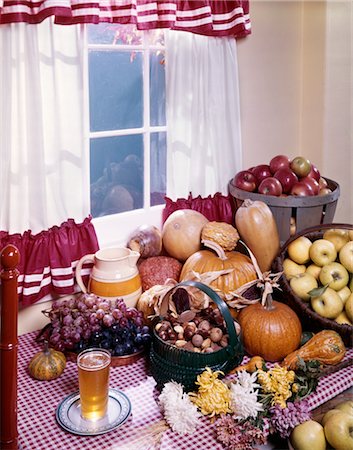 pumpkin still - 1960s AUTUMN HARVEST STILL LIFE VEGETABLES PUMPKIN APPLE SQUASH NUTS GRAPES CIDER RED WHITE KITCHEN TABLE CLOTH WINDOW LIGHT Stock Photo - Rights-Managed, Code: 846-02794334