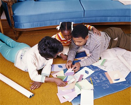 FAMILY LOOKING AT COLOR SWATCHES AND BLUEPRINTS Stock Photo - Rights-Managed, Code: 846-02794481