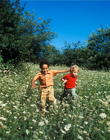 1970s LAUGHING BOYS RUNNING ON PLAYING FIELD Stock Photo - Rights-Managed, Code: 846-02794508