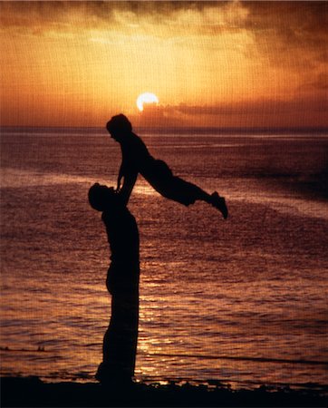 family sunset not portrait - SILHOUETTE FATHER LIFTING UP CHILD IN NATURAL YELLOW SUNSET Stock Photo - Rights-Managed, Code: 846-02794539