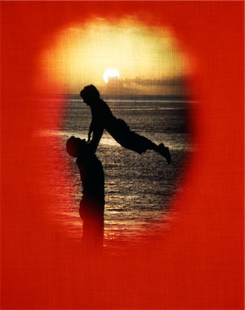 family up - 1970s SILHOUETTE FATHER LIFTING UP CHILD RED VIGNETTE LINEN TEXTURE YELLOW SUNSET Stock Photo - Rights-Managed, Code: 846-02794540