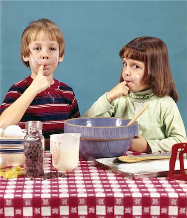 1970s RETRO BOY GIRL BROTHER SISTER MAKING COOKIES TASTING BATTER CHOCOLATE CHIPS BAKING COOKING Stock Photo - Rights-Managed, Code: 846-02794589