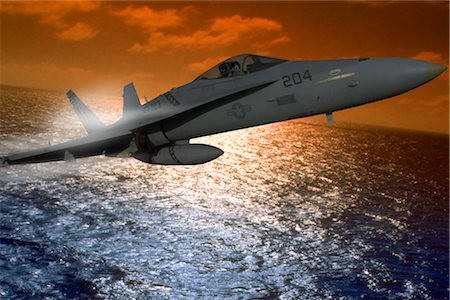 simsearch:846-03163699,k - USN FA-18A HORNET FLYING OVER OCEAN AT SUNSET Stock Photo - Rights-Managed, Code: 846-02794647