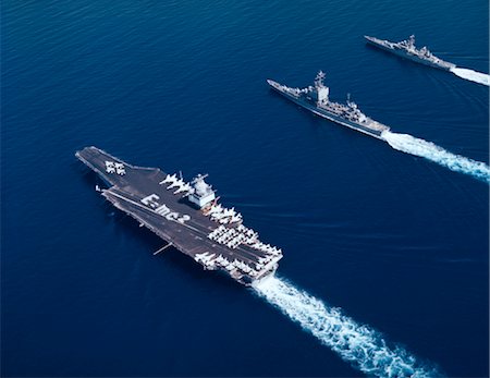 AERIAL VIEW OF THREE NAVAL VESSELS IN PARALLEL COURSES USS ENTERPRISE LONG BEACH AND BAINBRIDGE AIRCRAFT CARRIER CRUISER AND DESTROYER Stock Photo - Rights-Managed, Code: 846-02794699