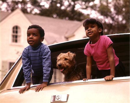 family car looking back - 1970s AFRICAN AMERICAN CHILDREN BOY GIRL PET DOG LOOKING OUT BACK WINDOW OF FAMILY STATION WAGON AUTOMOBILE Stock Photo - Rights-Managed, Code: 846-02794784