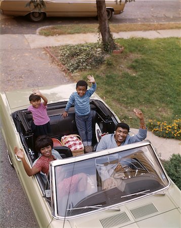 1960s HAPPY AFRICAN AMERICAN FAMILY FATHER MOTHER SON AND DAUGHTER WAVING FROM CONVERTIBLE AUTOMOBILE Stock Photo - Rights-Managed, Code: 846-02794785