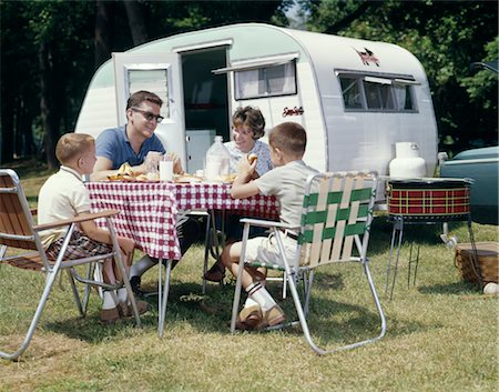 1960s FAMILY SITTING IN LAWN CHAIRS AT PICNIC TABLE BESIDE CAMPING TRAILER Stock Photo - Rights-Managed, Code: 846-02794852