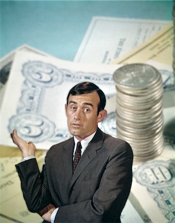 retro banking - 1960s BUSINESSMAN FACIAL EXPRESSION BACKGROUND MONEY CHECKS COINS FINANCE BANKING BUSINESS Stock Photo - Rights-Managed, Code: 846-02795014