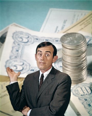 1960s BUSINESSMAN FACIAL EXPRESSION BACKGROUND MONEY CHECKS COINS FINANCE BANKING BUSINESS Stock Photo - Rights-Managed, Code: 846-02795016