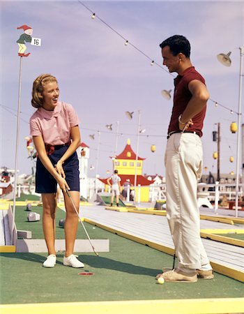 1960s YOUNG COUPLE PLAYING MINIATURE GOLF Stock Photo - Rights-Managed, Code: 846-02795205