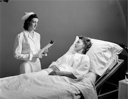 1950s NURSE PATIENT WOMAN BED HOSPITAL SICKNESS ILLNESS Stock Photo - Rights-Managed, Code: 846-02795435