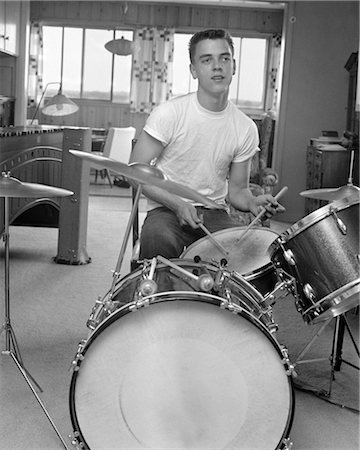 1960s TEEN BOY WITH BUZZ CUT IN T-SHIRT SITTING IN FRONT OF SMALL DRUM KIT HOLDING STICKS OVER SNARE Stock Photo - Rights-Managed, Code: 846-02795446