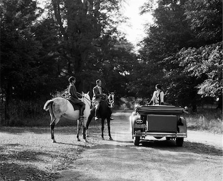 rich lifestyle car - 1920s 1930s COUPLE ON HORSES MEETING WOMAN ON ROAD IN CONVERTIBLE TOURING CAR Stock Photo - Rights-Managed, Code: 846-02795468