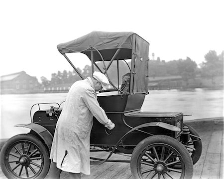 simsearch:846-02795516,k - 1930s MECHANIC IN WHITE SMOCK CHECKING EARLY ROE Stock Photo - Rights-Managed, Code: 846-02795479