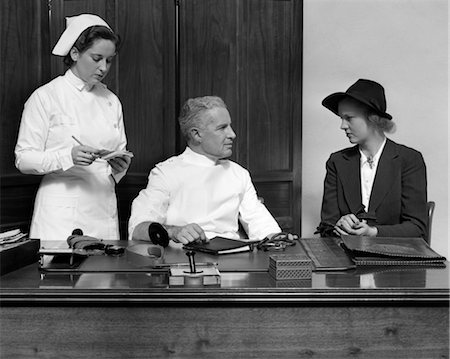 simsearch:846-02794819,k - NURSE DOCTOR PATIENT CONSULTATION DESK RETRO 1940s 1950s Stock Photo - Rights-Managed, Code: 846-02795521