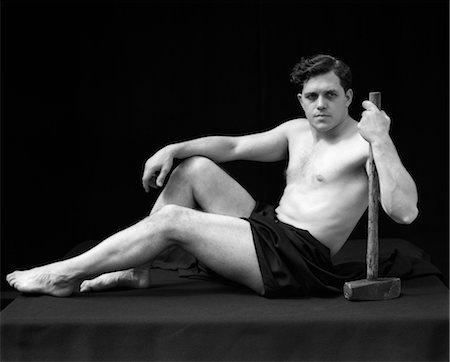1920s MAN SEMI NUDE CLASSICAL POSE SITTING HOLDS LONG ARMED HAMMER RETRO VINTAGE Stock Photo - Rights-Managed, Code: 846-02795670