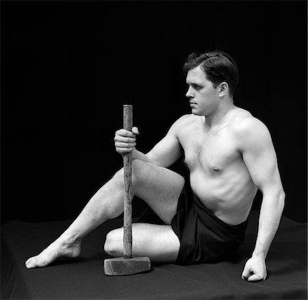simsearch:846-02797122,k - 1920s MAN SEMI NUDE CLASSICAL POSE HOLDING LONG ARMED HAMMER RETRO VINTAGE Stock Photo - Rights-Managed, Code: 846-02795671