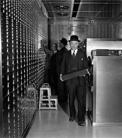 simsearch:846-02796076,k - MEN MAN CARRY CARRYING SAFETY DEPOSIT BOX WEAR HAT SUIT VAULT 1930s INSPECT BANK VALUABLE Stock Photo - Rights-Managed, Code: 846-02795879