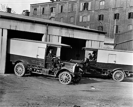 1910s 1920s PAIR OF DELIVERY DRIVERS ONE PULLING TRUCK INTO & ONE PULLING TRUCK OUT OF GARAGE Stock Photo - Rights-Managed, Code: 846-02795898