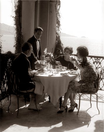 simsearch:846-02797510,k - 1920s GROUP EATING ON BALCONY WITH WAITER SERVING WINE Stock Photo - Rights-Managed, Code: 846-02796020